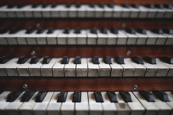 Keys on a big old brown church organ — 스톡 사진