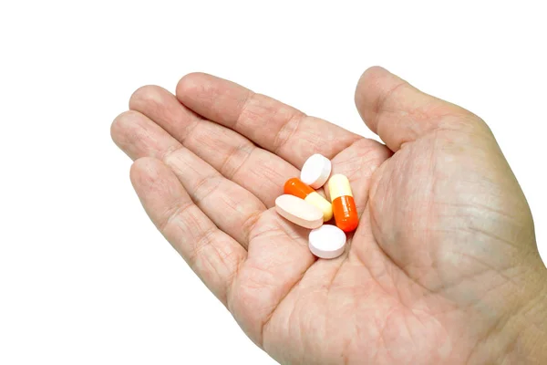 Cápsula e comprimido de medicamento à mão — Fotografia de Stock