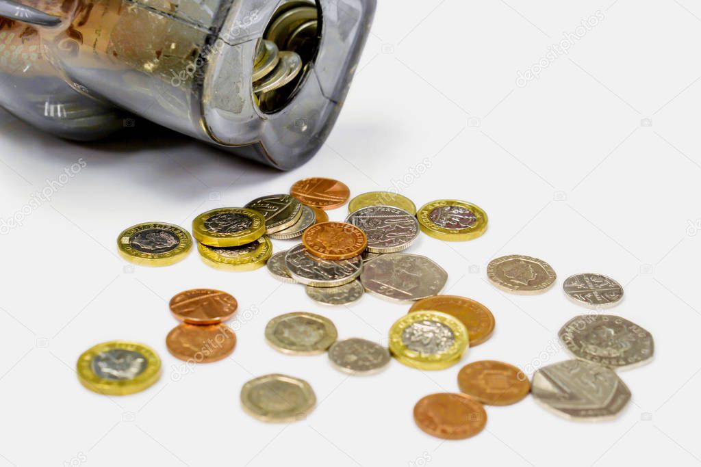 British currency coins open from the piggy bank laid out scatter