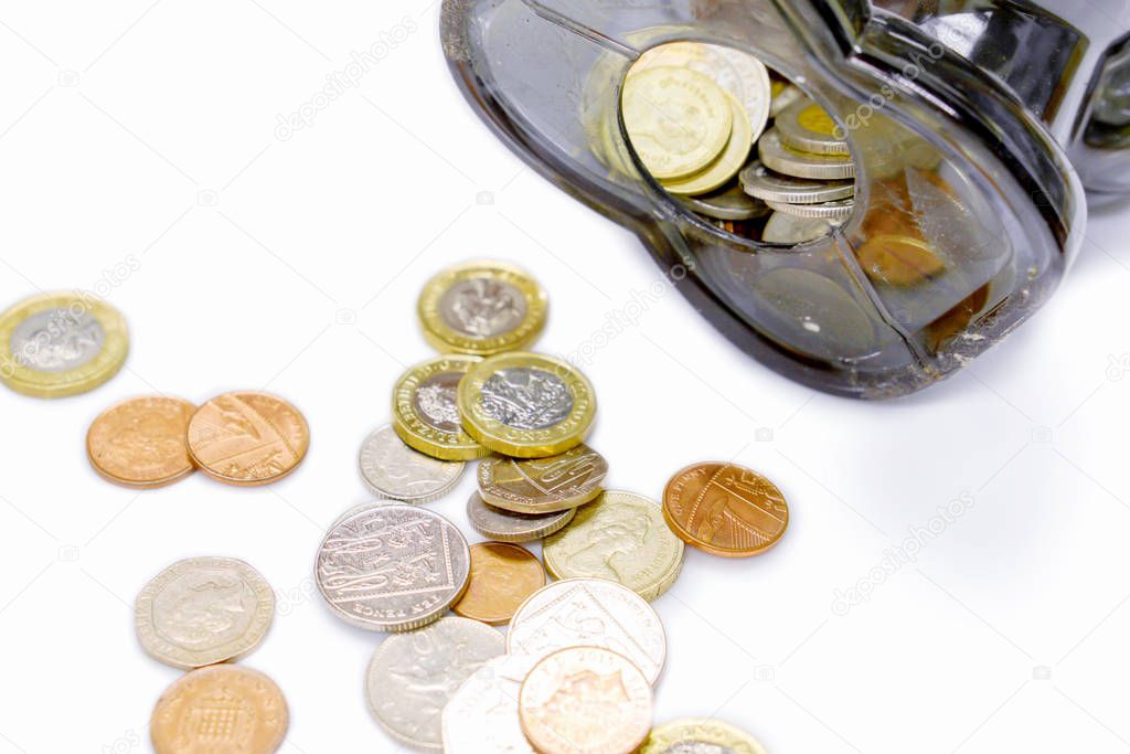 Top view of British currency coins open from the piggy bank laid