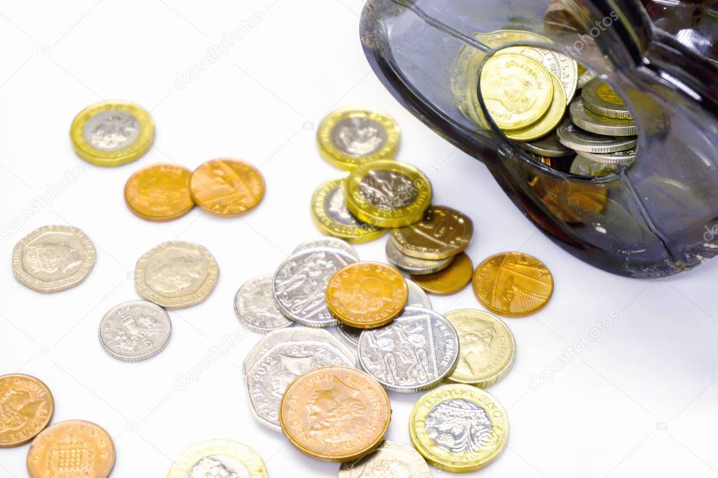 Top view of British currency coins open from the piggy bank laid