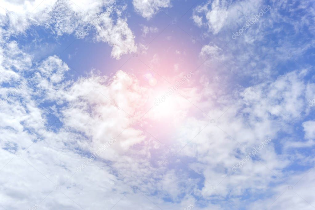 Background and texture of bright blue sky and cotton clouds with sun lights on afternoon summer.