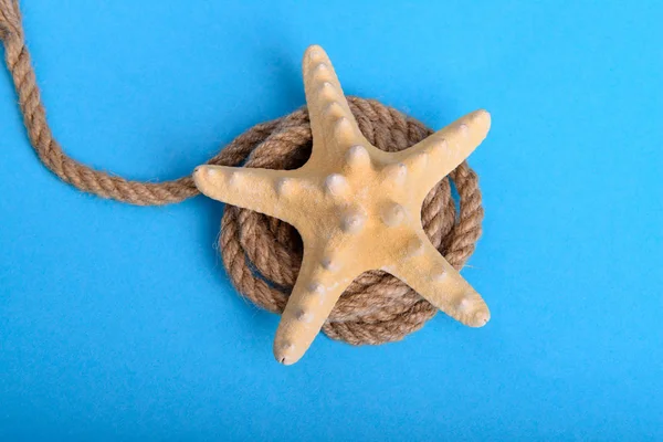 Big starfish on a rope in blue background — Stock Fotó