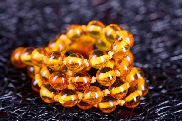 amber beads accessory on black background