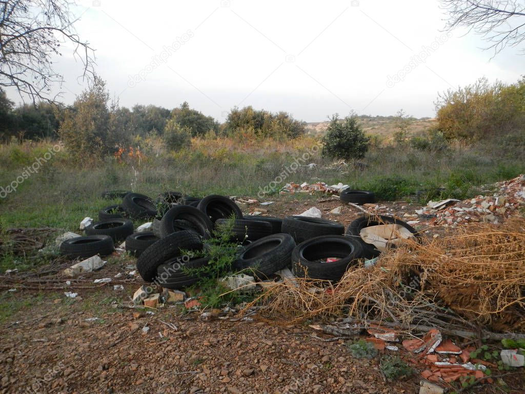 Pile of worn tires in nature