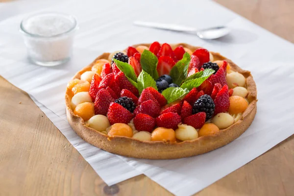 Fruit tartlet on baking pape — Stock Photo, Image