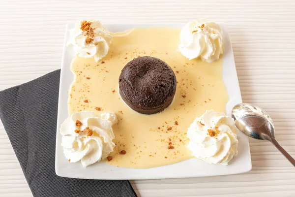 Chocolate fondant with custard and whipped cream