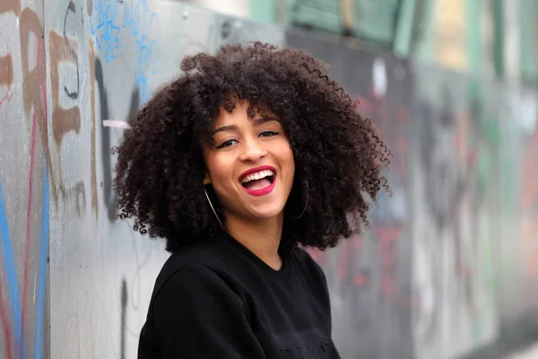 Closeup portrait of a smiling black woman with curly hair