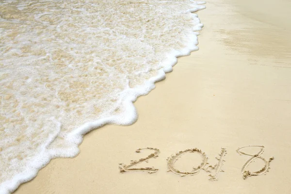 2018 written on the sand of a beach — Stock Photo, Image