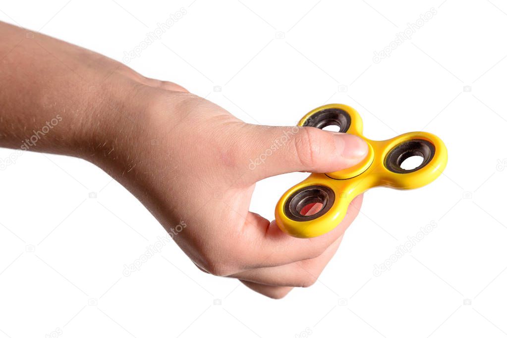 hand holding yellow fidget spinner