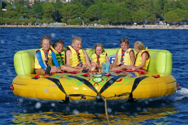 Kids having great fun on crazy ufo, water sport — Stock Photo, Image