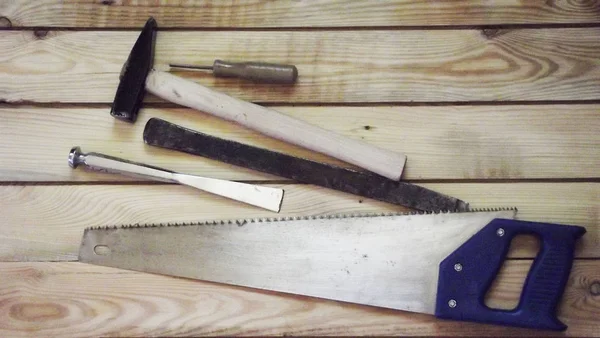 Bench tools on a wooden background.