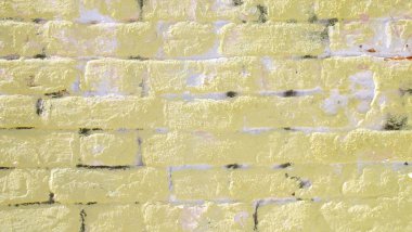 Güzel sarı arka plan. Tuğla duvar.