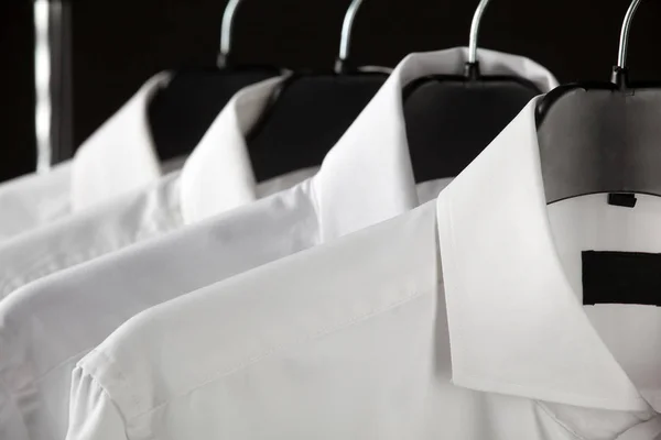 Male shirts hanging in row — Stock Photo, Image