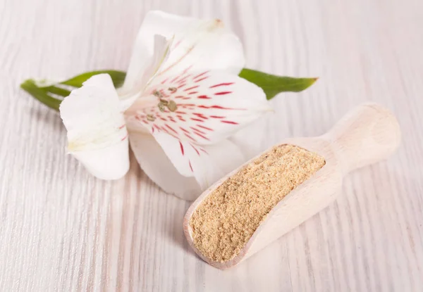 Delicate flower and ayurvedic powder — Stock Photo, Image