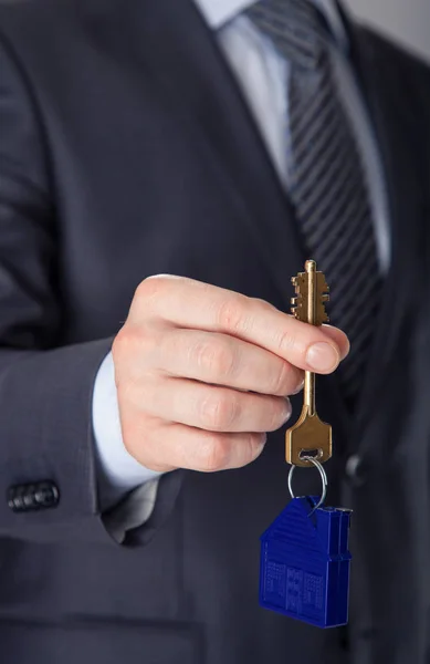 Businessman offering key from house — Stock Photo, Image