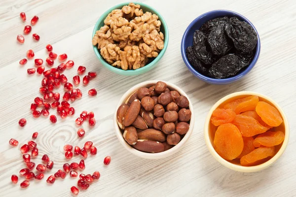 Bowls with nuts and dried fruits — Stock Photo, Image
