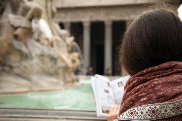 Woman tourist reading travel guide