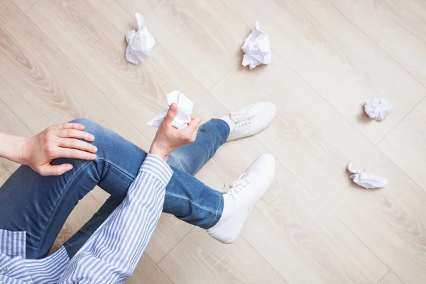 Woman crumpling papers and throwing them