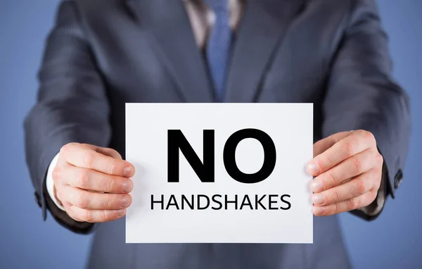 Unerkennbarer Geschäftsmann erinnert daran, Händeschütteln zu vermeiden — Stockfoto