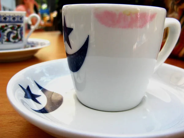 Traditional turkish coffee in turkish coffee cups. Female lipstick on a coffee cup.