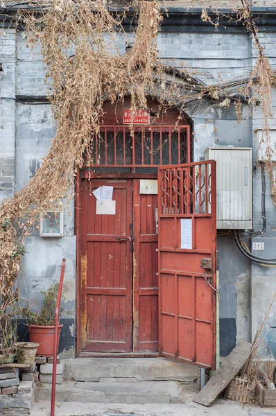 Gammal röd trädörr av en traditionell hutong bostäder byggnad, Beijing — Stockfoto