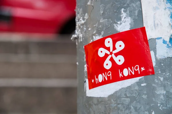 Pegatina de una bandera de Hong Kong pegada a un poste de luz en Sheung Wan, Hong Kong — Foto de Stock