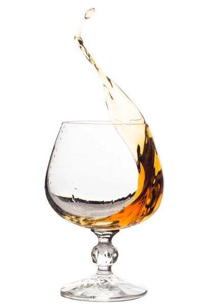 Splash of brandy in glass. Royalty Free Stock Images