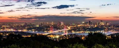 Istanbul Bosphorus Bridge at sunset. 15th July Martyrs Bridge. Night view from Camlica Hill. Istanbul, Turkey clipart