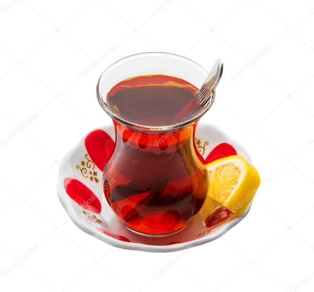 Turkish Tea in traditional glass with traditional tea plate. Turkish Tea glass with thin waist with lemon slice. Isolated white background. Clipping Path