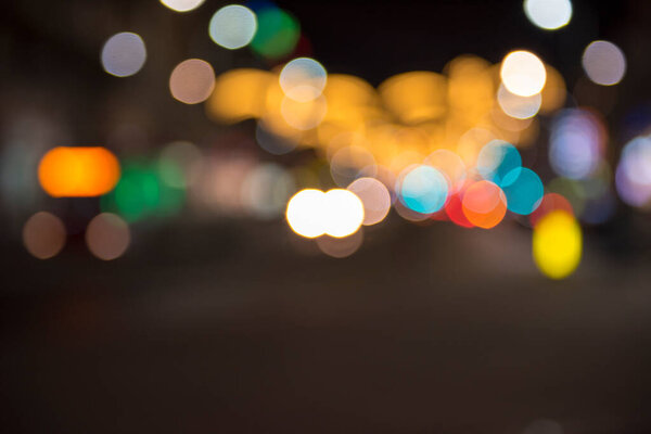 Christmas lights with blur bokeh. Night lights on street. Bokeh light abstract background