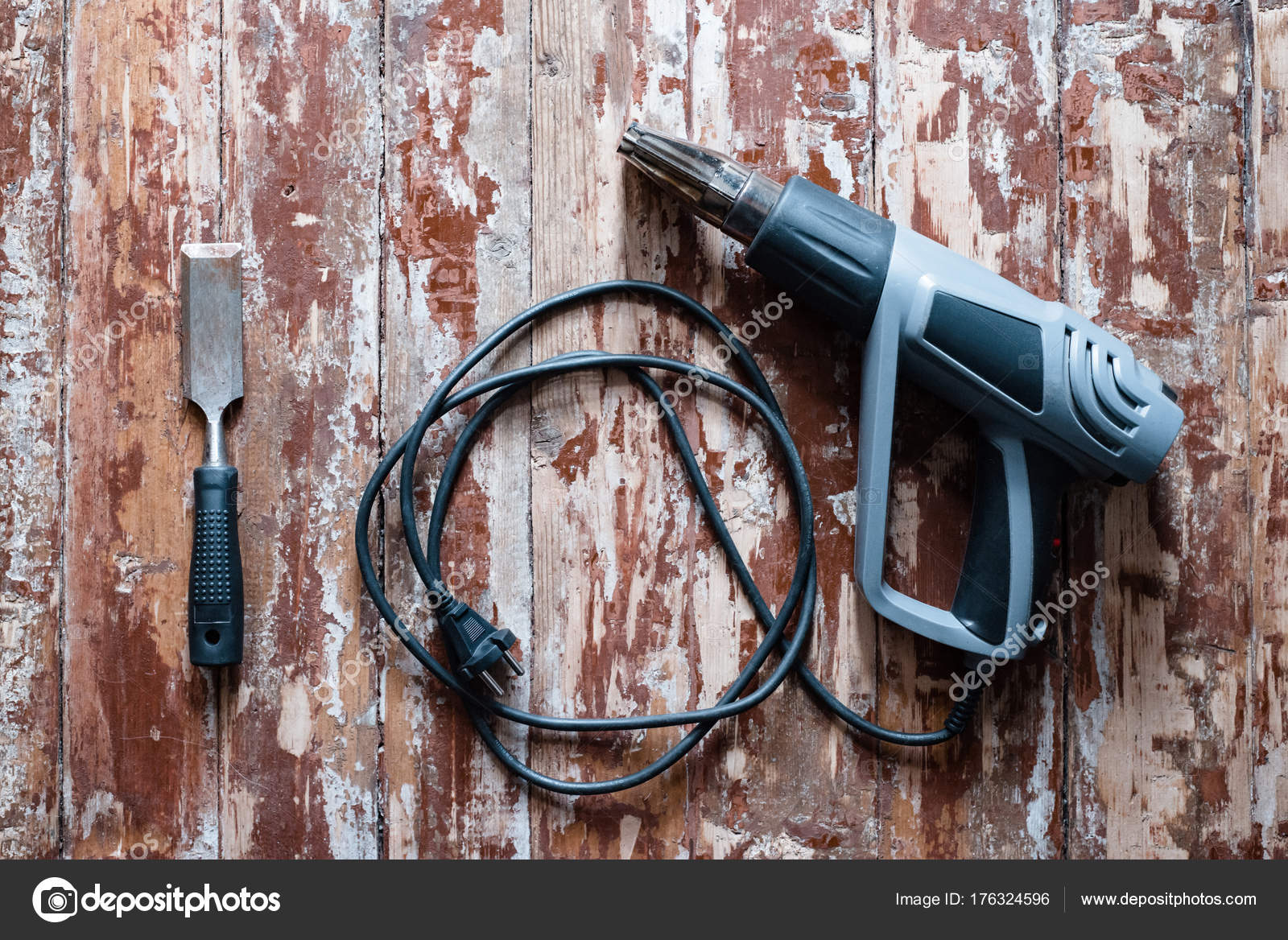 Removing paint from the floor with a hot air gun repair tools Stock