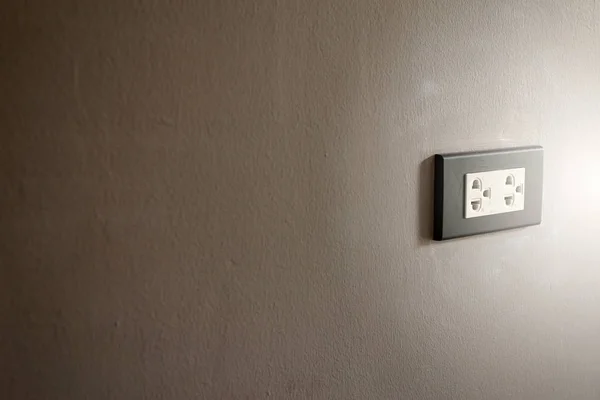 Electronic house plug on white wall