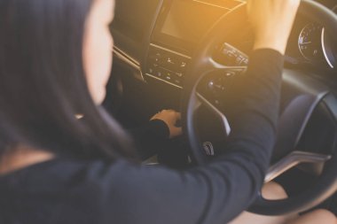 Eller kadın holding direksiyon simidi ve otomatik vites üzerinde bir araba