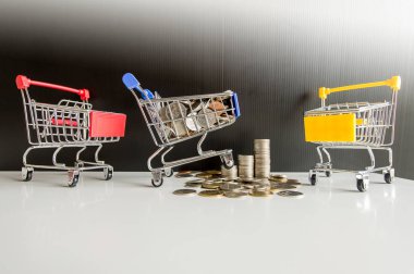 Mini alışveriş sepeti ile adım para yığınları, finans ve para kavramı alışveriş