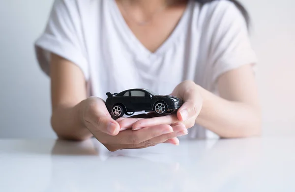 Car model on hand,Business and finance concept