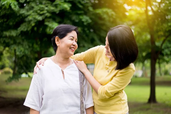 Senior asian older mother happy with hand daughter take care and support,Close up