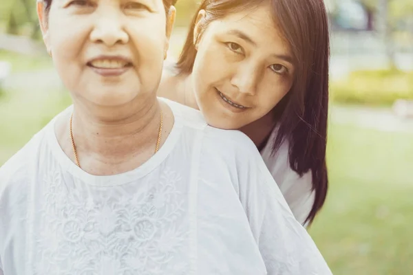 Asian middle mother happy with daughter at nature,Positive thinking,Happy and smiling,Elderly social asia concept,Selective focus