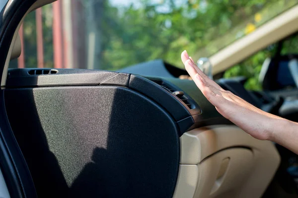 Closeup of hand woman checking flow cold from air conditioner in modern car,Cooling system in car,Auto air conditioning