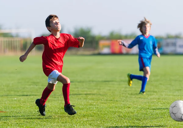 Ragazzi che giocano a calcio gioco sul campo sportivo — Foto Stock