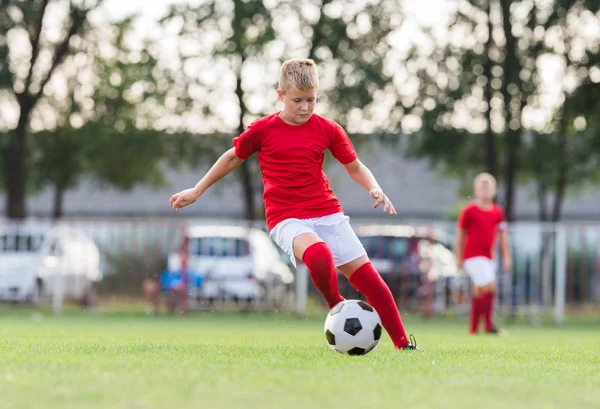 Boy kicking soccer ball — Stock Photo, Image