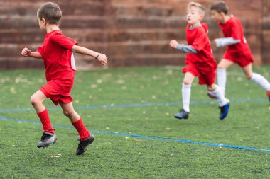  Spor sahasında futbol topu tekmeleme çocuklar