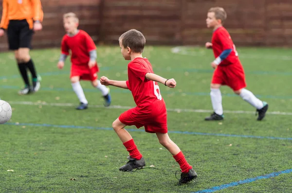 Boy kicking soccer ball — Stock Photo, Image