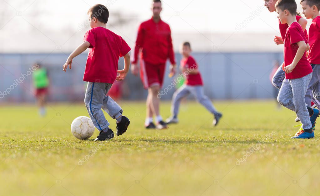 Kids soccer football - children players match on soccer field 