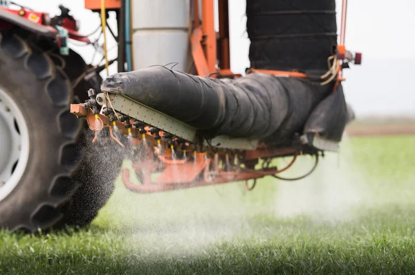 Tractor pulverización de pesticidas en campo de trigo con pulverizador —  Fotos de Stock