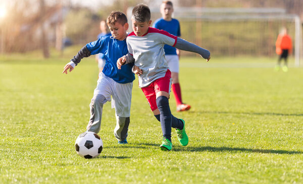 Kids soccer football - children players match on soccer field 