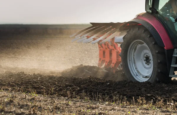 Tractor plowing fields  -preparing land for sowings — Stock Photo, Image