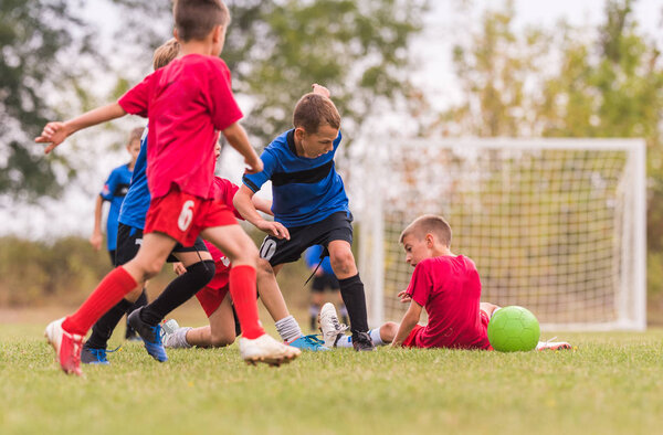 Kids soccer football - children players match on soccer field 