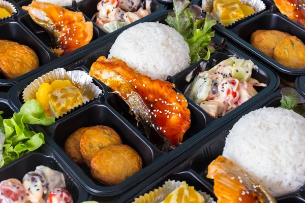 Asian lunch boxes in plastic packages. Royalty Free Stock Photos