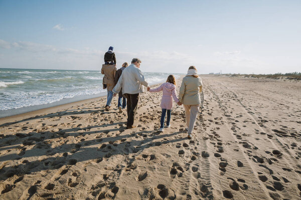 family walking at seaside